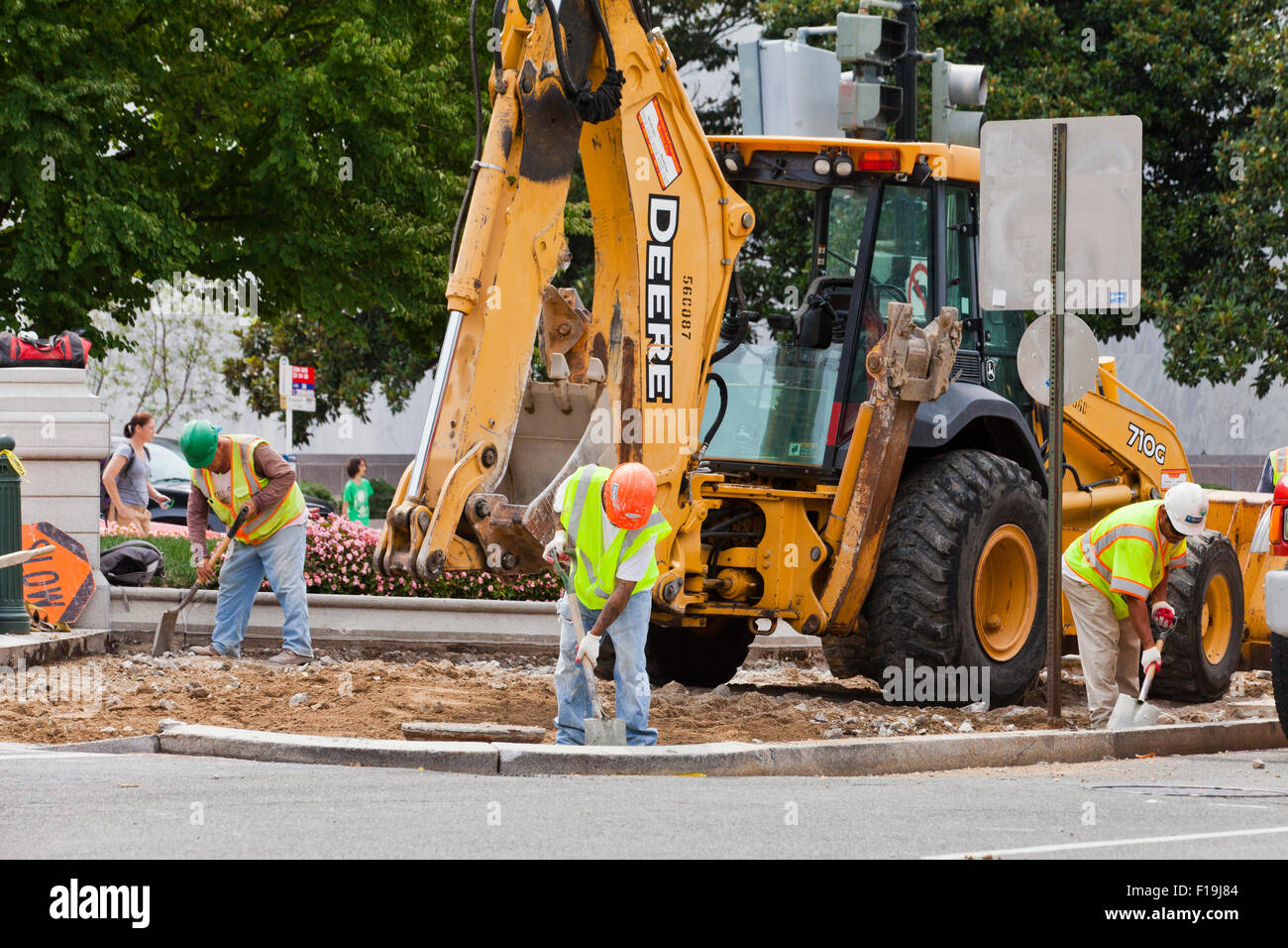 Municipal construction workers using backhoe - USA Stock Photo