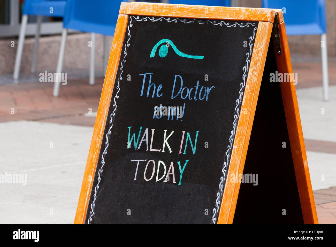 'The Doctor is In' sign in front of neighborhood medical care facility - USA Stock Photo