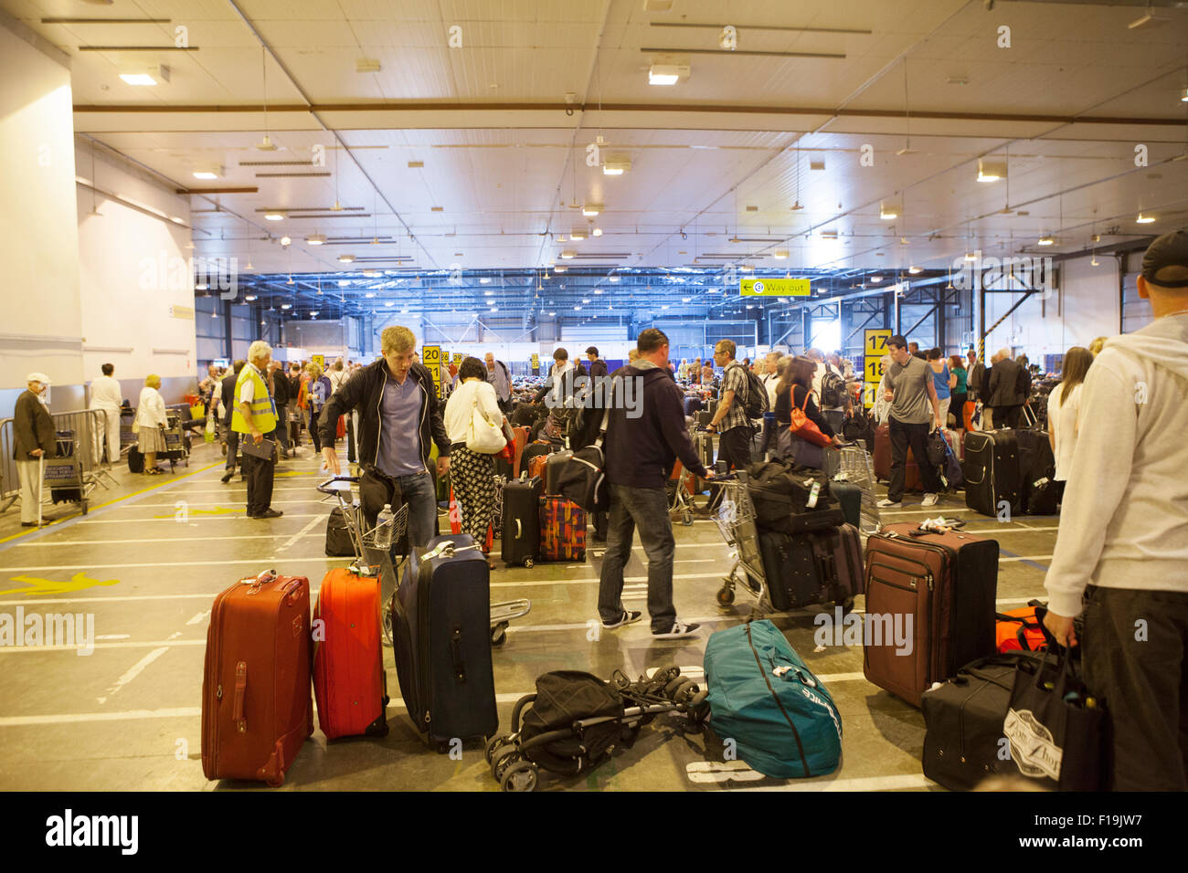 Passengers at the baggage claim area with all their luggage Stock Photo