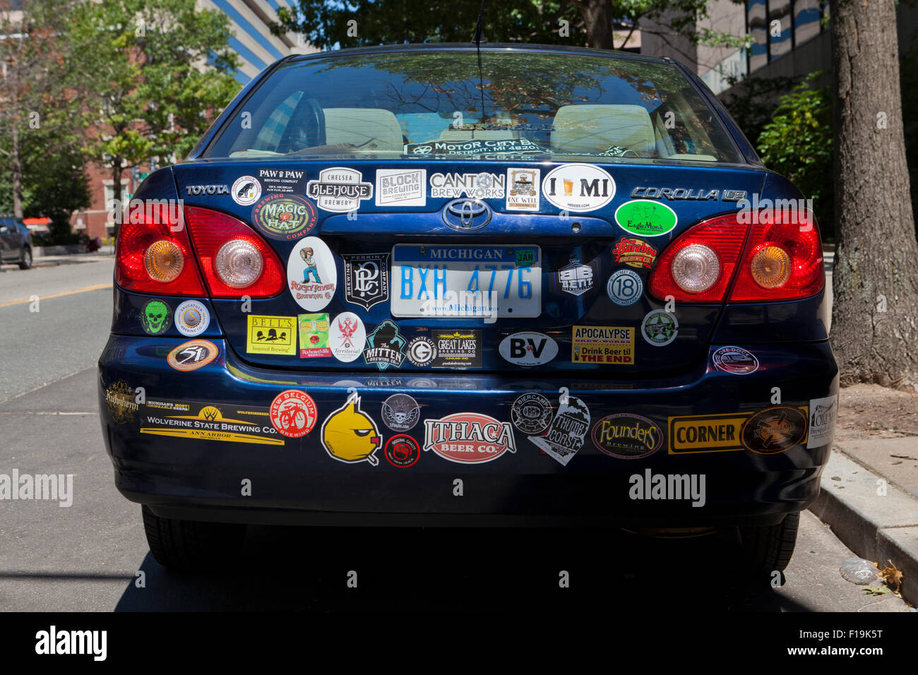 Multiple bumper stickers on back of compact car of a beer lover - USA Stock Photo
