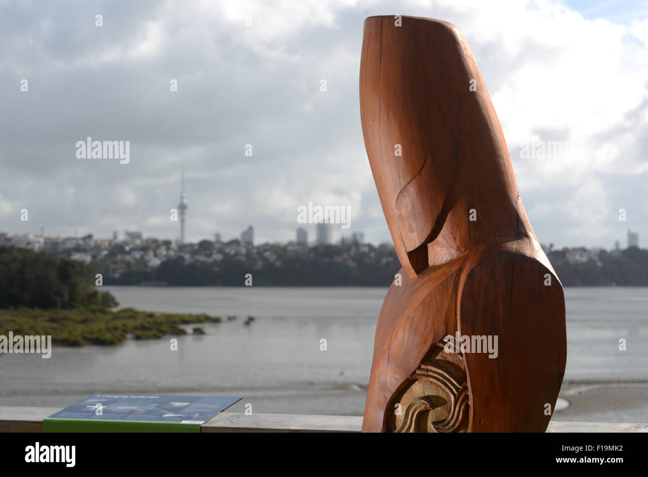 AUCKLAND, NEW ZEALAND, July 16, 2015: A carving of a Maori pou or guardian overlooks the Orakei Basin in Auckland Stock Photo