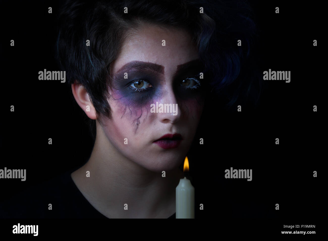Teen holding candle in the dark hi-res stock photography and images - Alamy