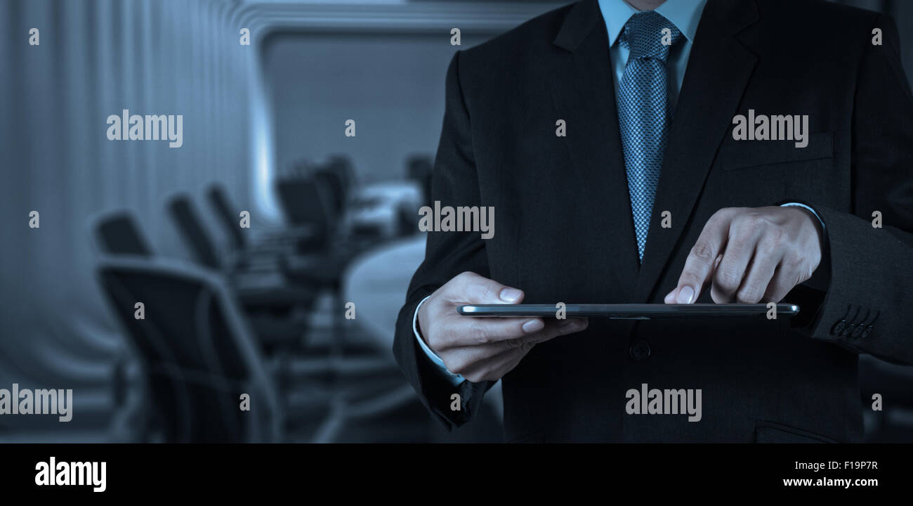 Businessman hand working with a digital tablet on meeting room ...