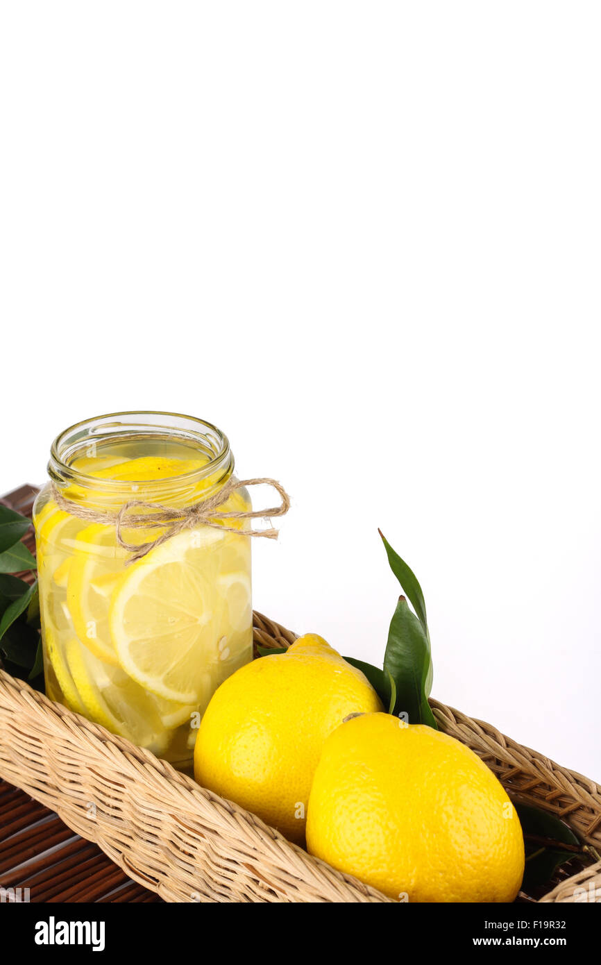 lemonade with some uncut lemon inside a basket ready copy space Stock Photo