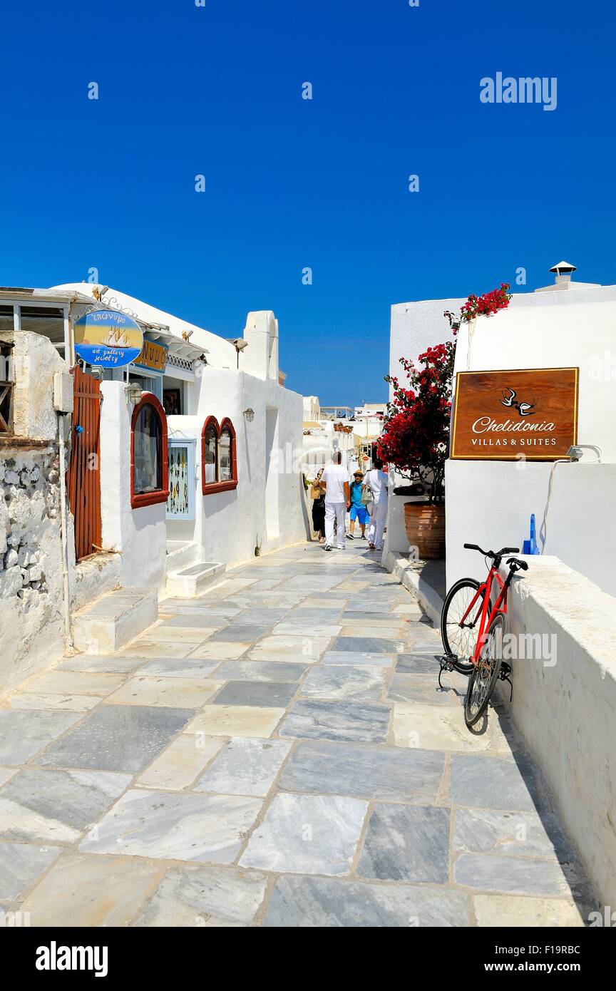 A narrow paved street in the village of Oia Santorini Greece Stock Photo