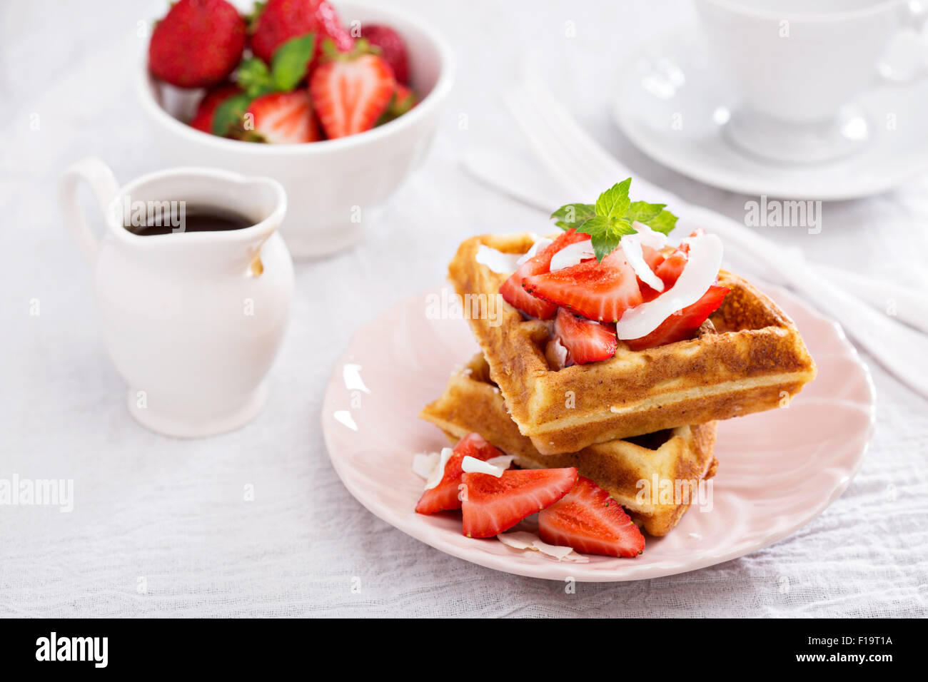 Ricotta waffles served with fresh strawberries and maple syrup Stock Photo