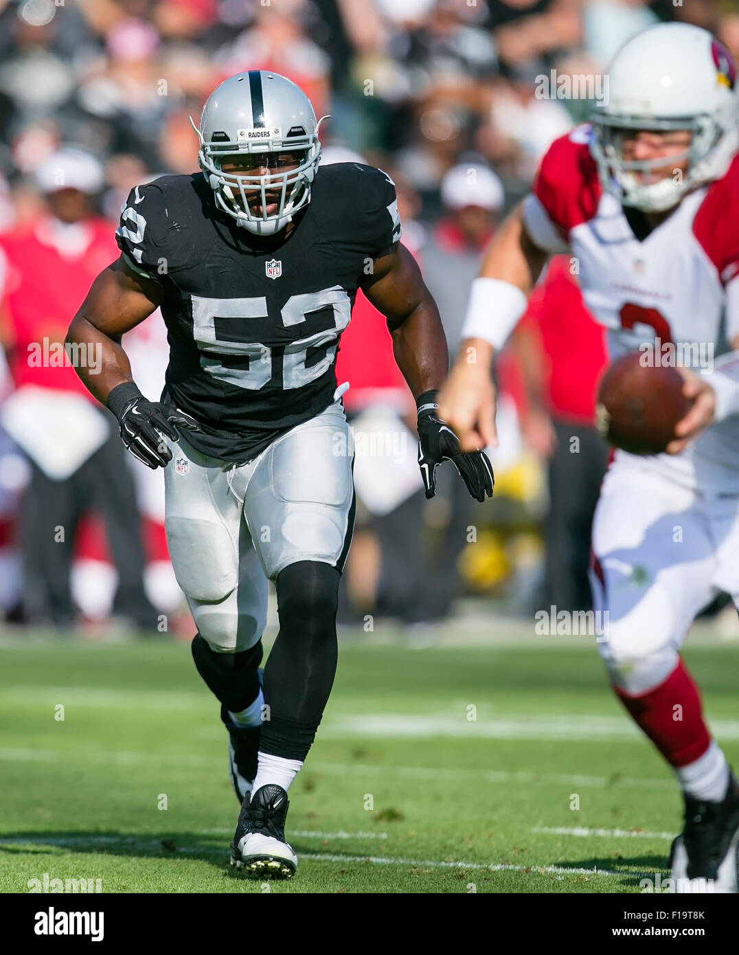 Oakland, CA. 30th Aug, 2015. Oakland Raiders outside linebacker Khalil Mack (52) in action during the NFL football game between the Oakland Raiders and the Arizona Cardinals at the O.co Coliseum in Oakland, CA. The Cardinals defeated the Raiders 30-23. Damon Tarver/Cal Sport Media/Alamy Live News Stock Photo
