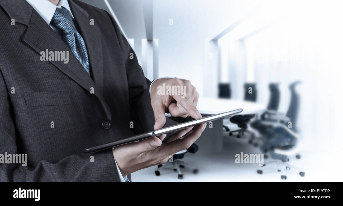 Businessman hand working with a digital tablet on meeting room ...