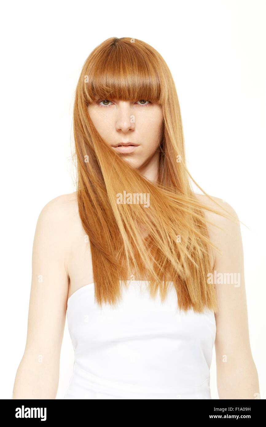 Blond hair. Young woman with long, straight hair in wind with bangs Stock Photo