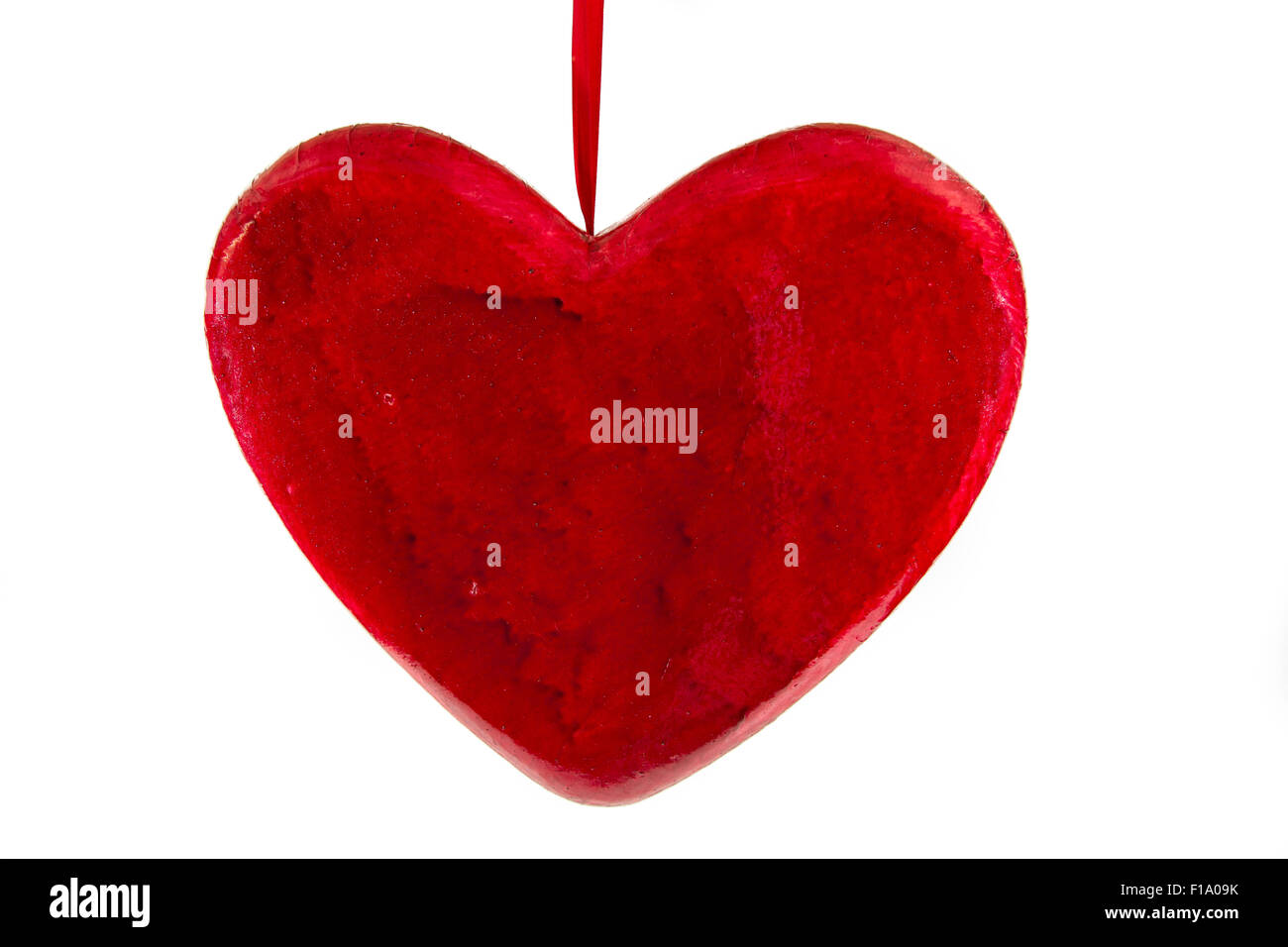 red heart on a white background tied a red thread Stock Photo