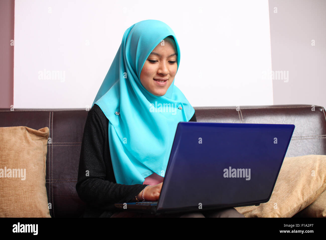 young muslim women relaxing on the sofa with laptop Stock Photo - Alamy