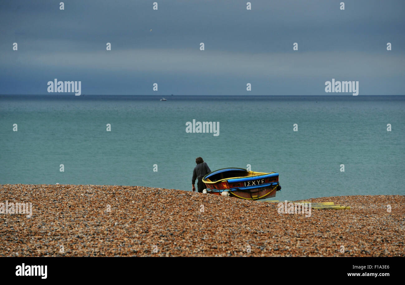 Brighton UK Monday 31st August 2015 - A fisherman heads out from Brighton beach early this August Bank Holiday Monday morning Stock Photo