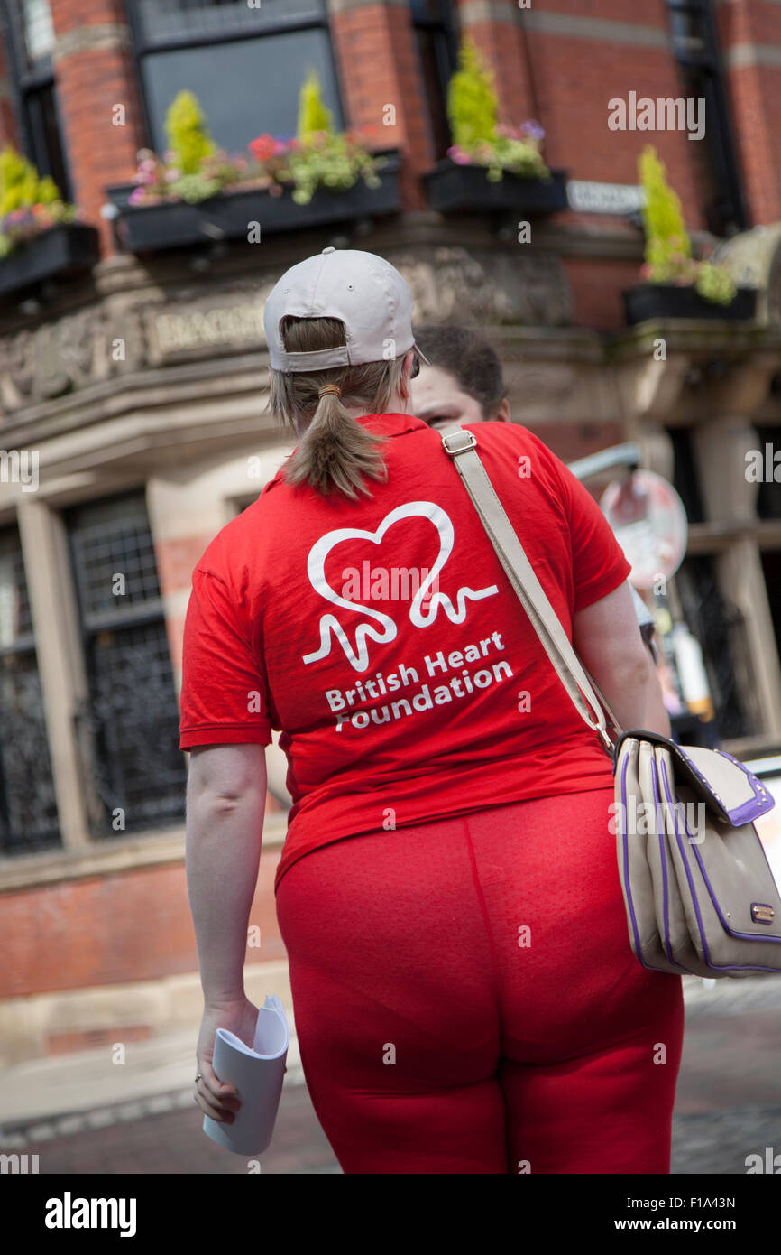 Rear View Of British Heart Foundation Charity Face To Face Female Fundraiser Charity Persuading