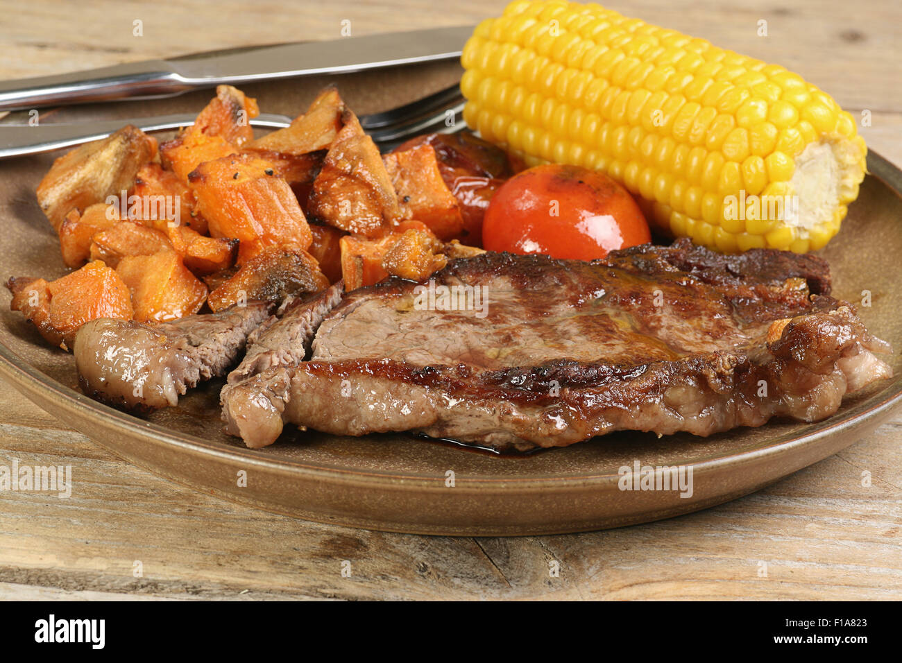 grilled sirloin steak with corn cob and sweet potato Stock Photo