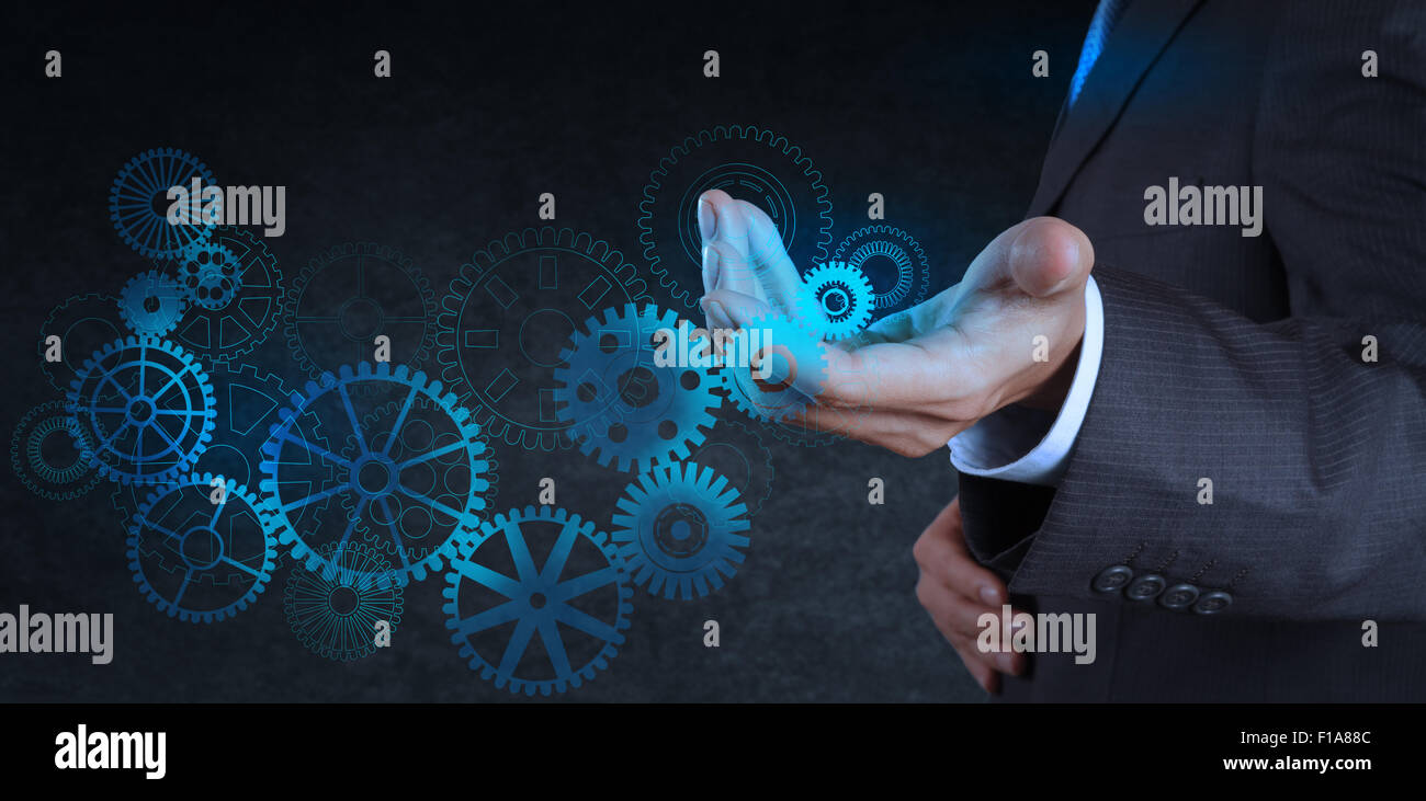 businessman hand touch blue gear to success as concept Stock Photo - Alamy