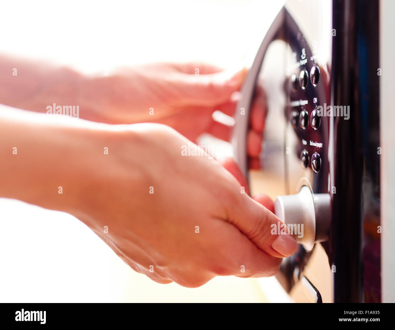 Using microwave oven, close up photo, shallow dof Stock Photo