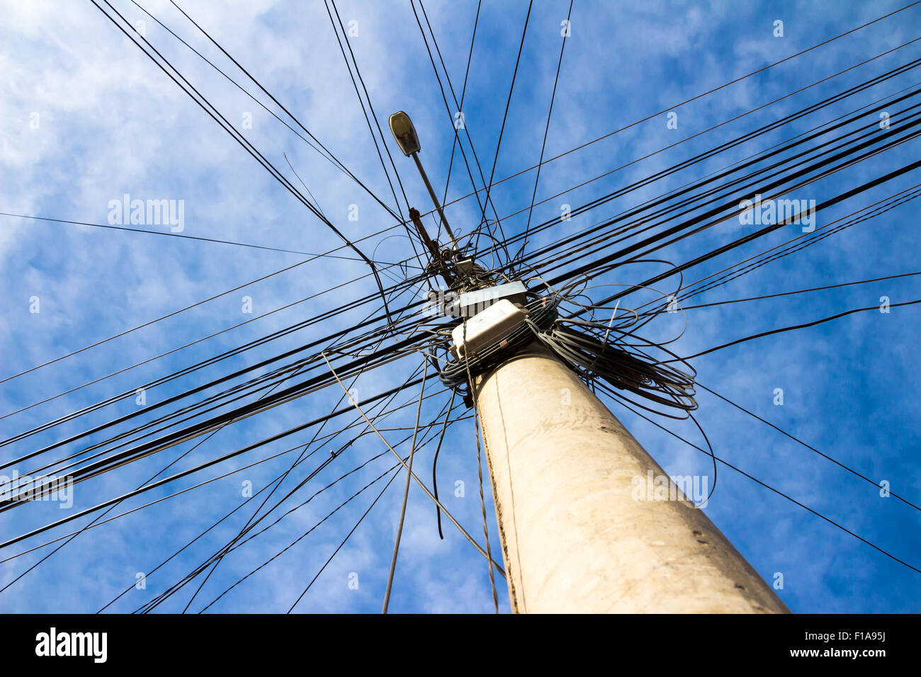 Lamp post with many cables that run in different directions Stock Photo