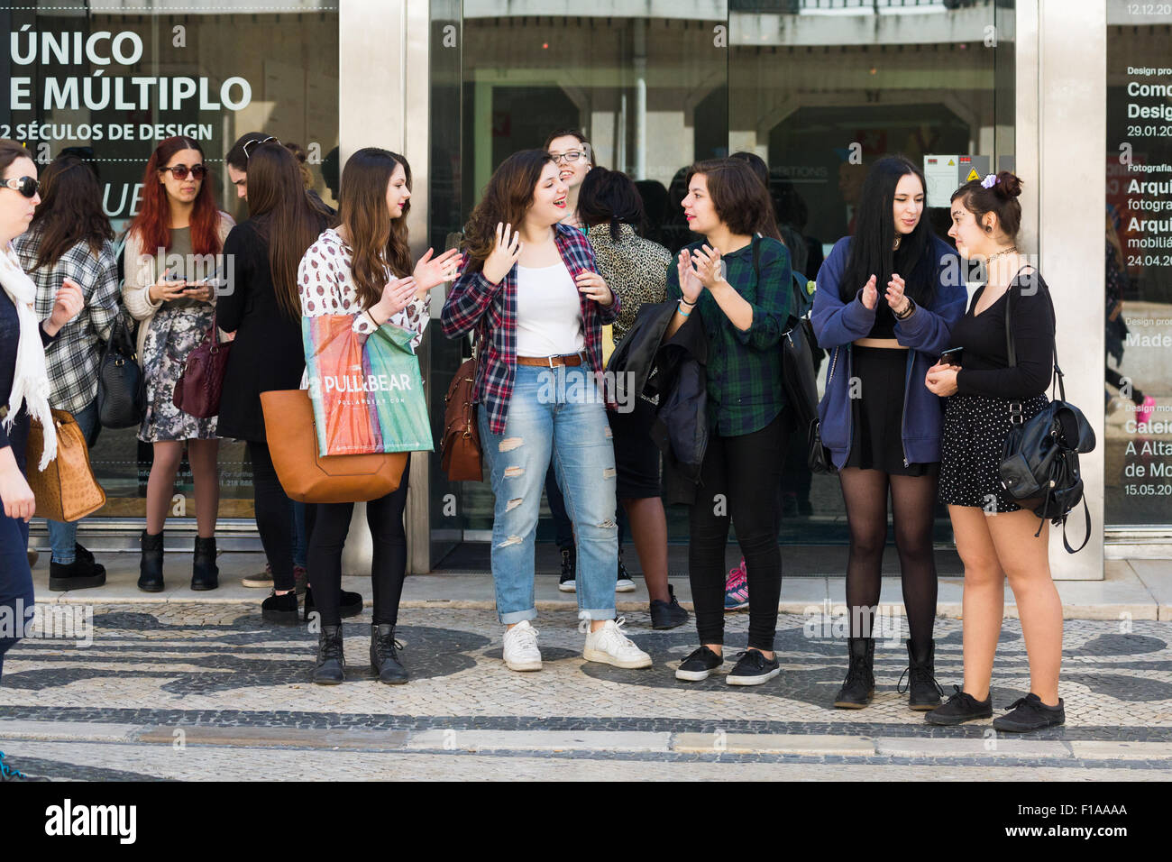 young teenagers outside on sidewalk.Central Lisbon Portugal Stock Photo