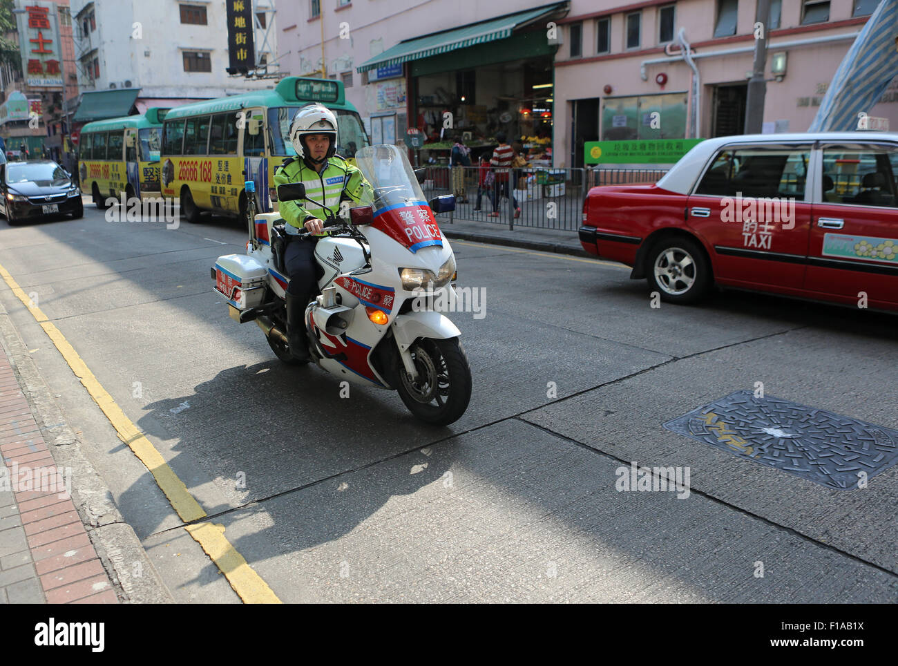 Hong Kong, China, policeman riding a motorcycle Stock Photo