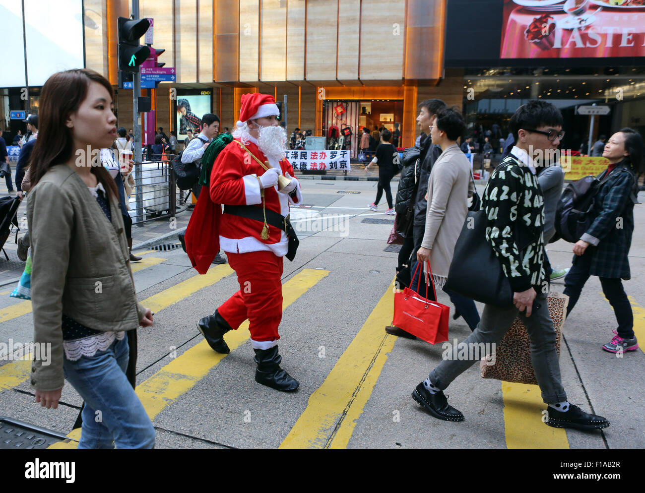 Hong Kong, China, Santa Claus about crossing a busy street Stock Photo