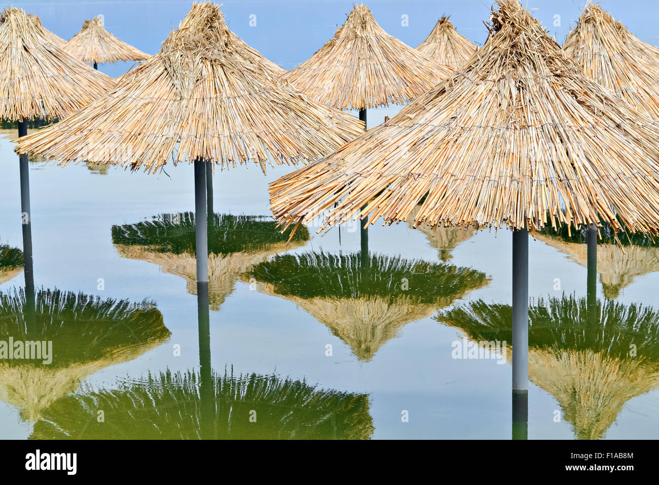 Reed sunshades flooded after heavy rains connected with climate changes Stock Photo