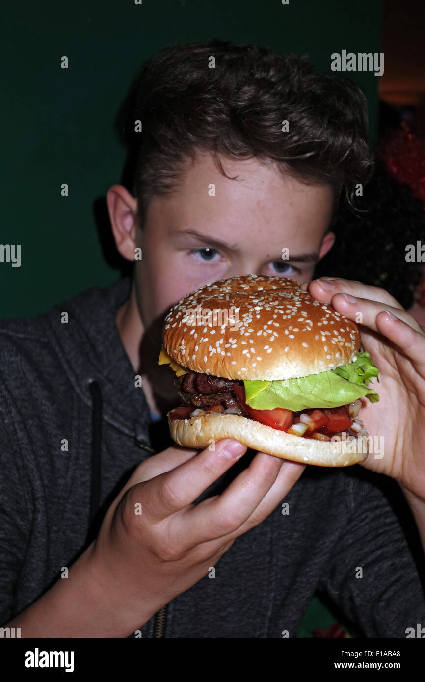 Berlin, Germany, boy eating a burger Stock Photo