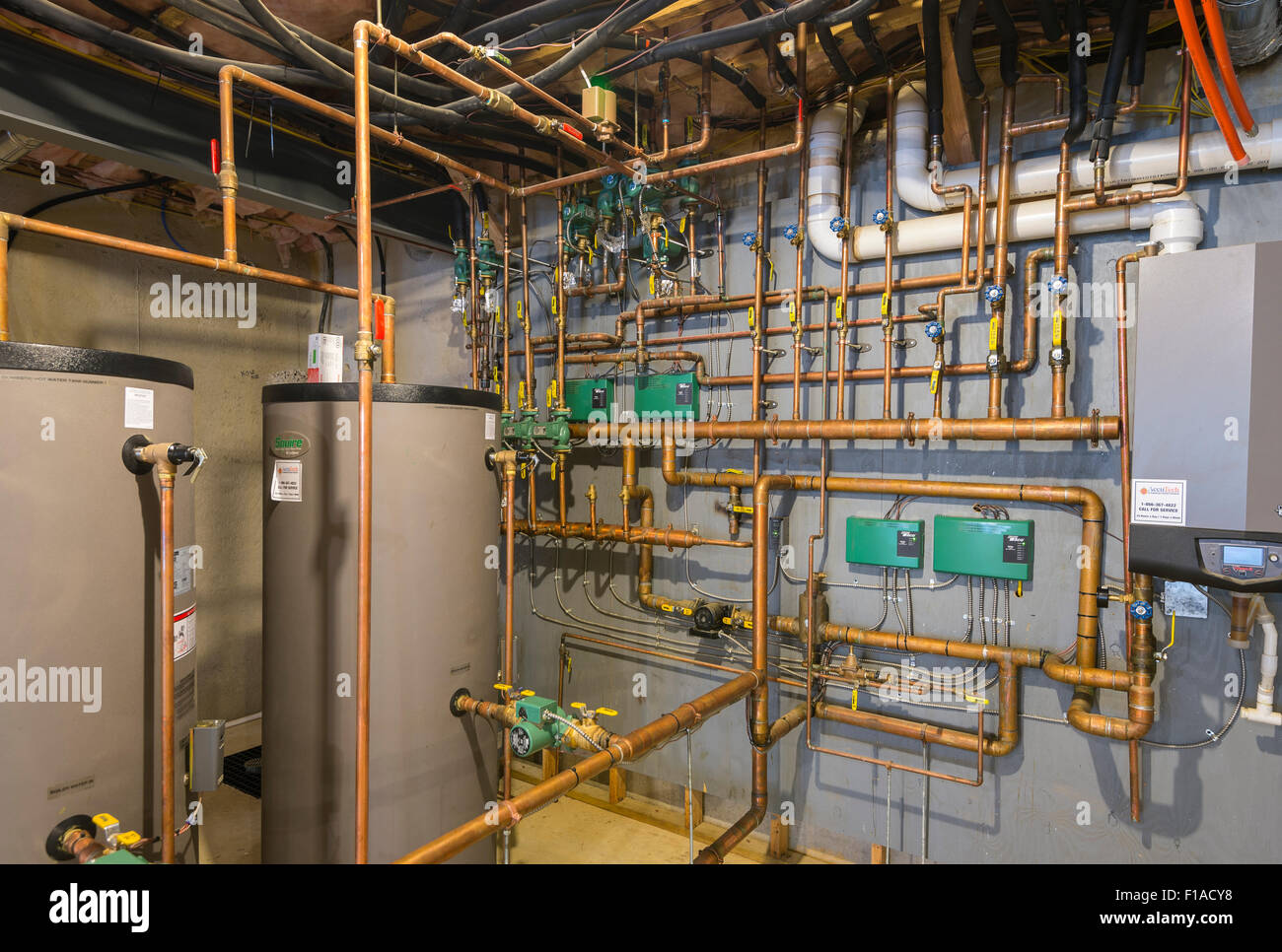 Copper Water Pipes In Basement Of New Large Home Stock Photo