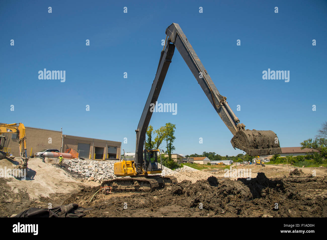 Large Backhoe At Construction Site Stock Photo