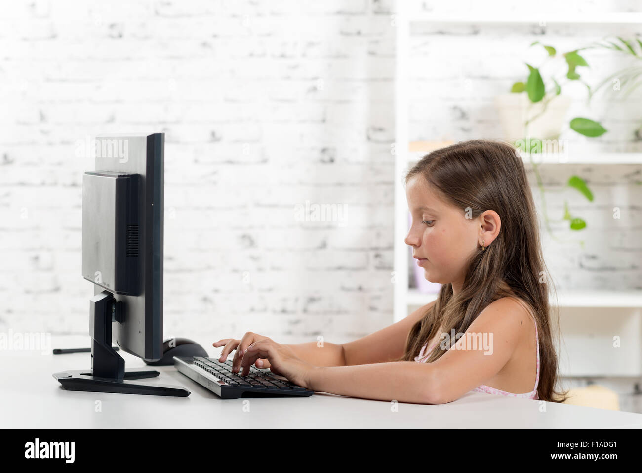 a schoolgirl working on a computer Stock Photo - Alamy