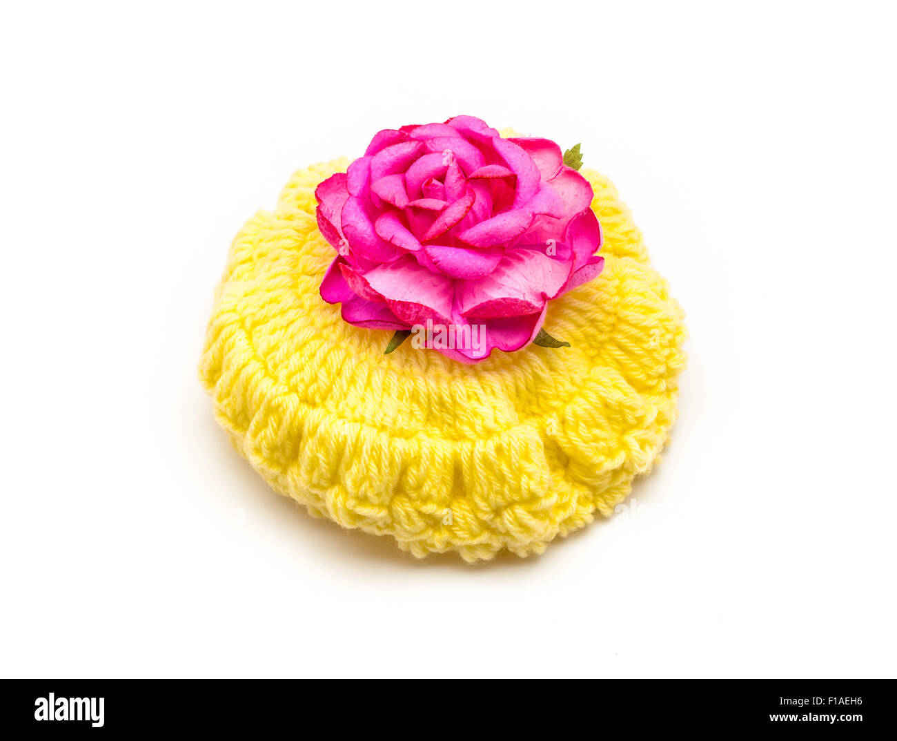 Yellow Wool hat with Pink Rose. Stock Photo