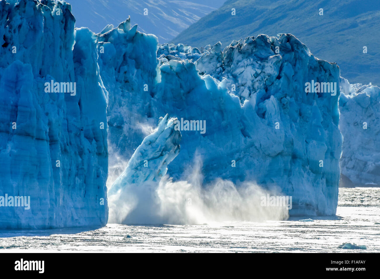 Alaska cruise - calving glacier - Hubbard - global warming & climate change - a melting iceberg calves - St. Elias Alaska - Yukon, Canada Stock Photo