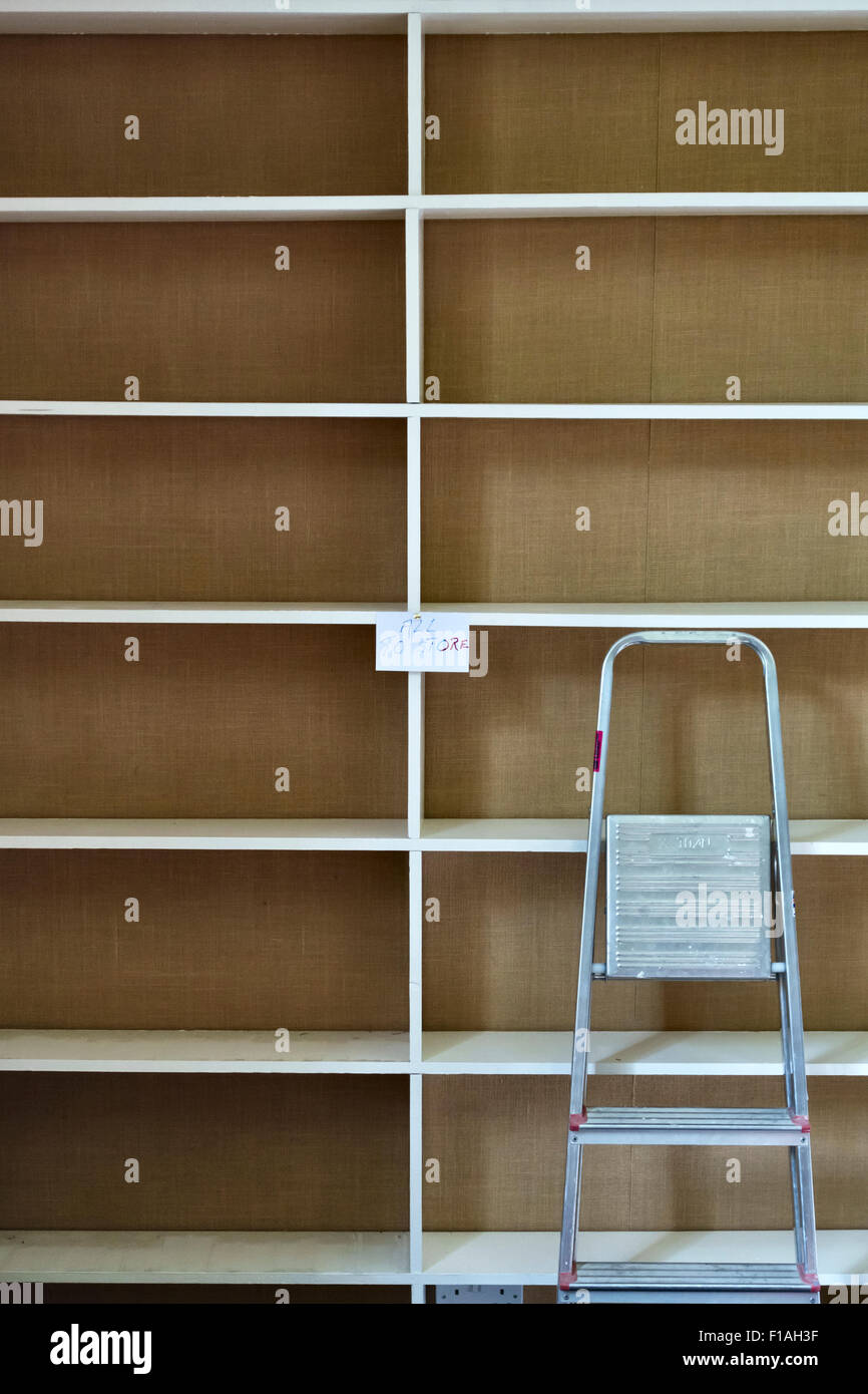 Moving house - empty bookshelves and a stepladder Stock Photo