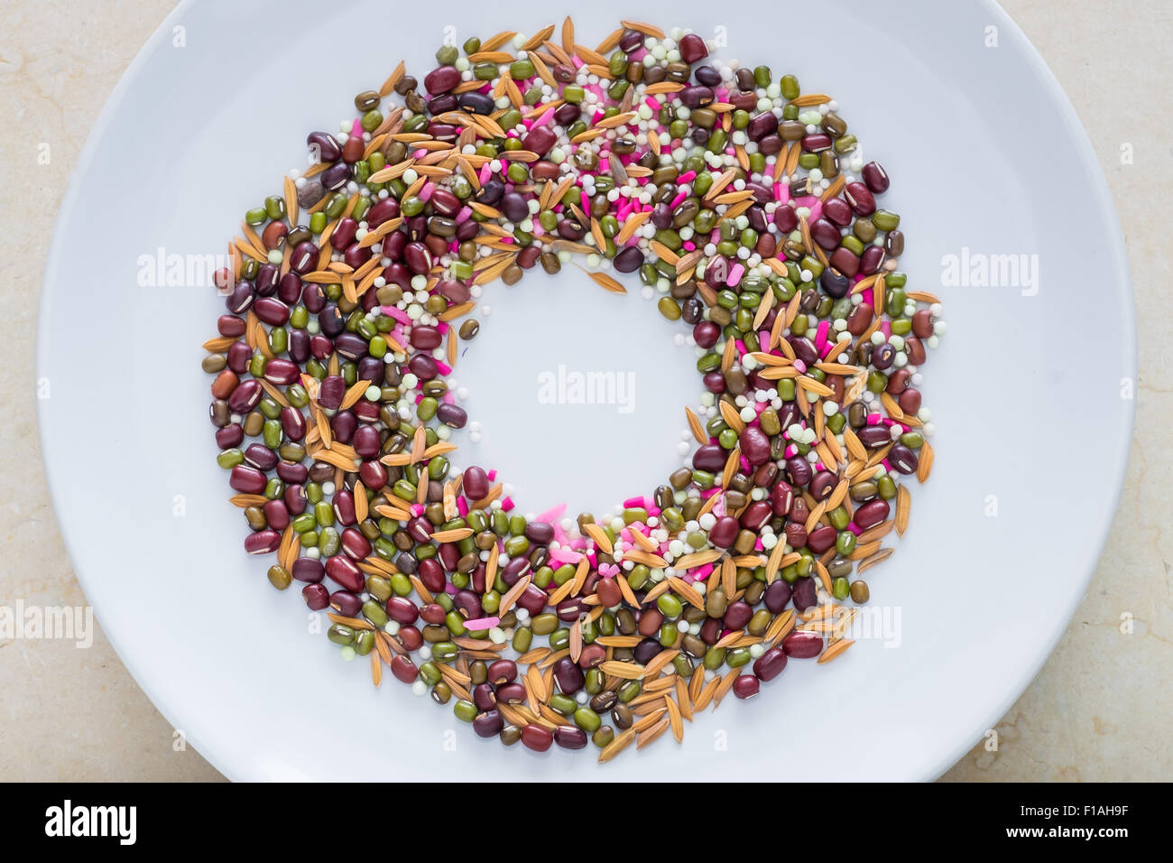 Mix of seeds (bean grain paddy) put on the white plate. Stock Photo