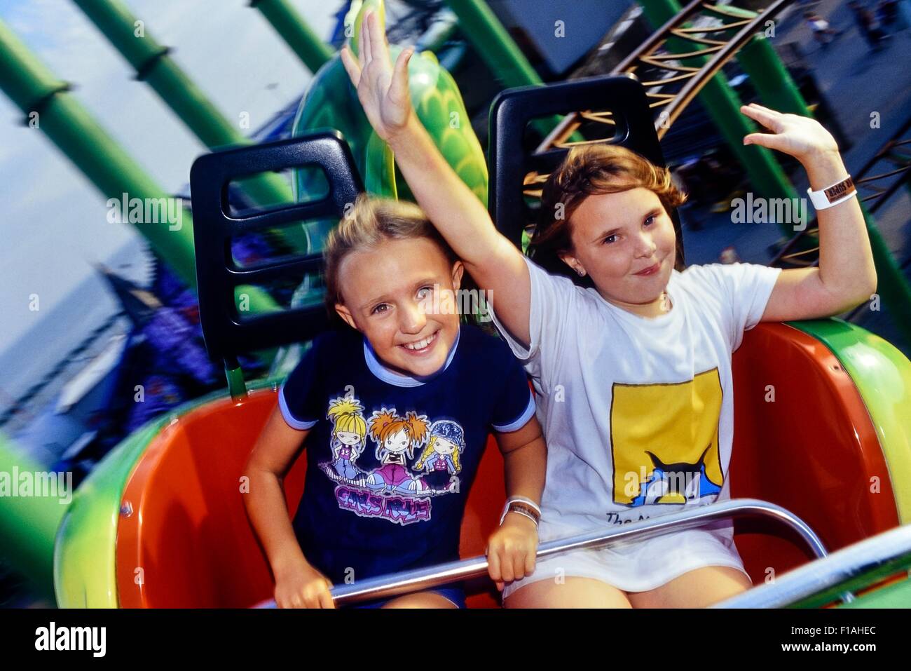 Two girls screaming on the green scream roller coaster at Pleasure Island. Southend. Essex. UK Stock Photo