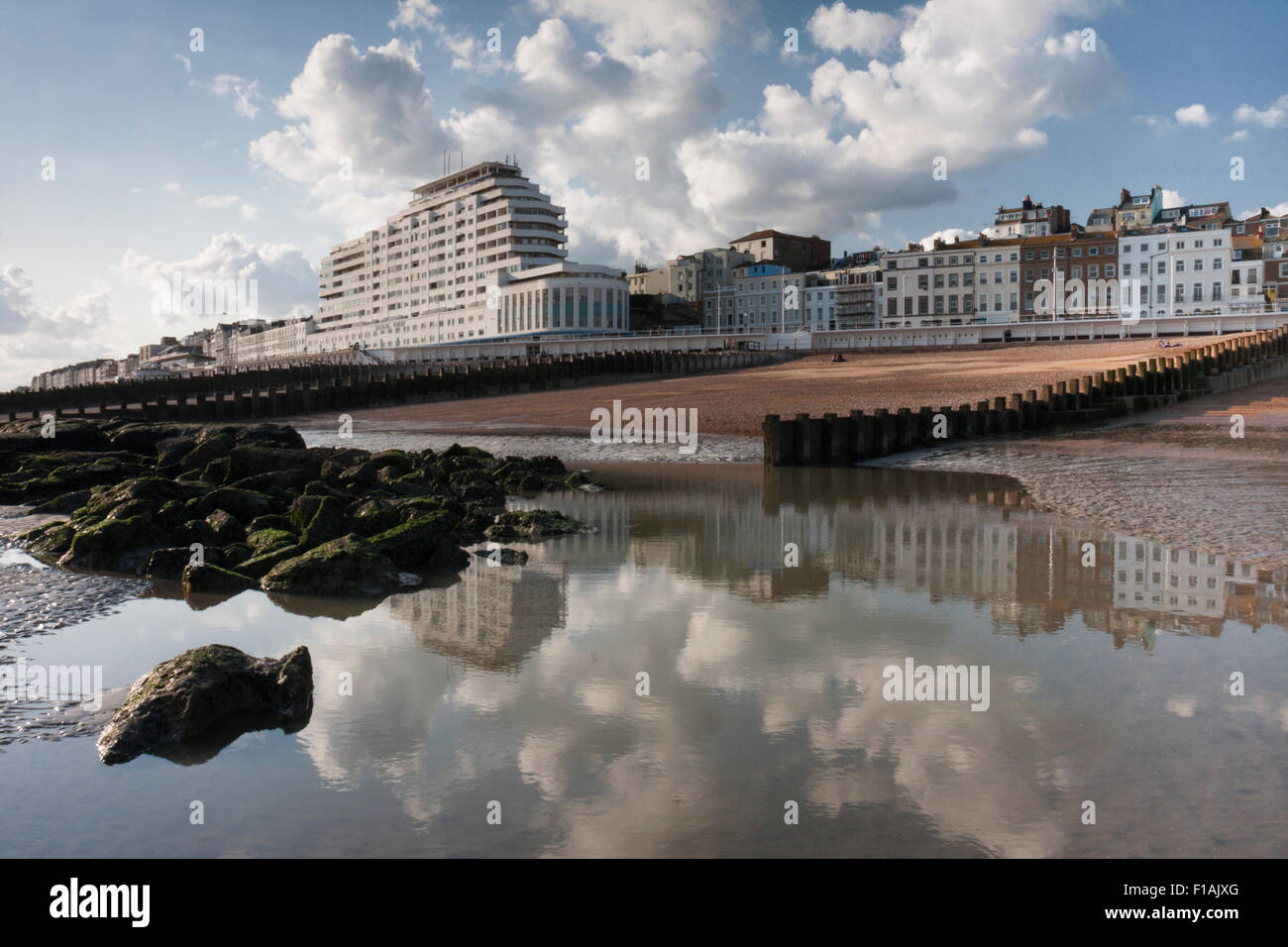 Marine Court, a 1930's art deco building, reflected in a tidal pool at St Leonards on Sea, East Sussex, England Stock Photo