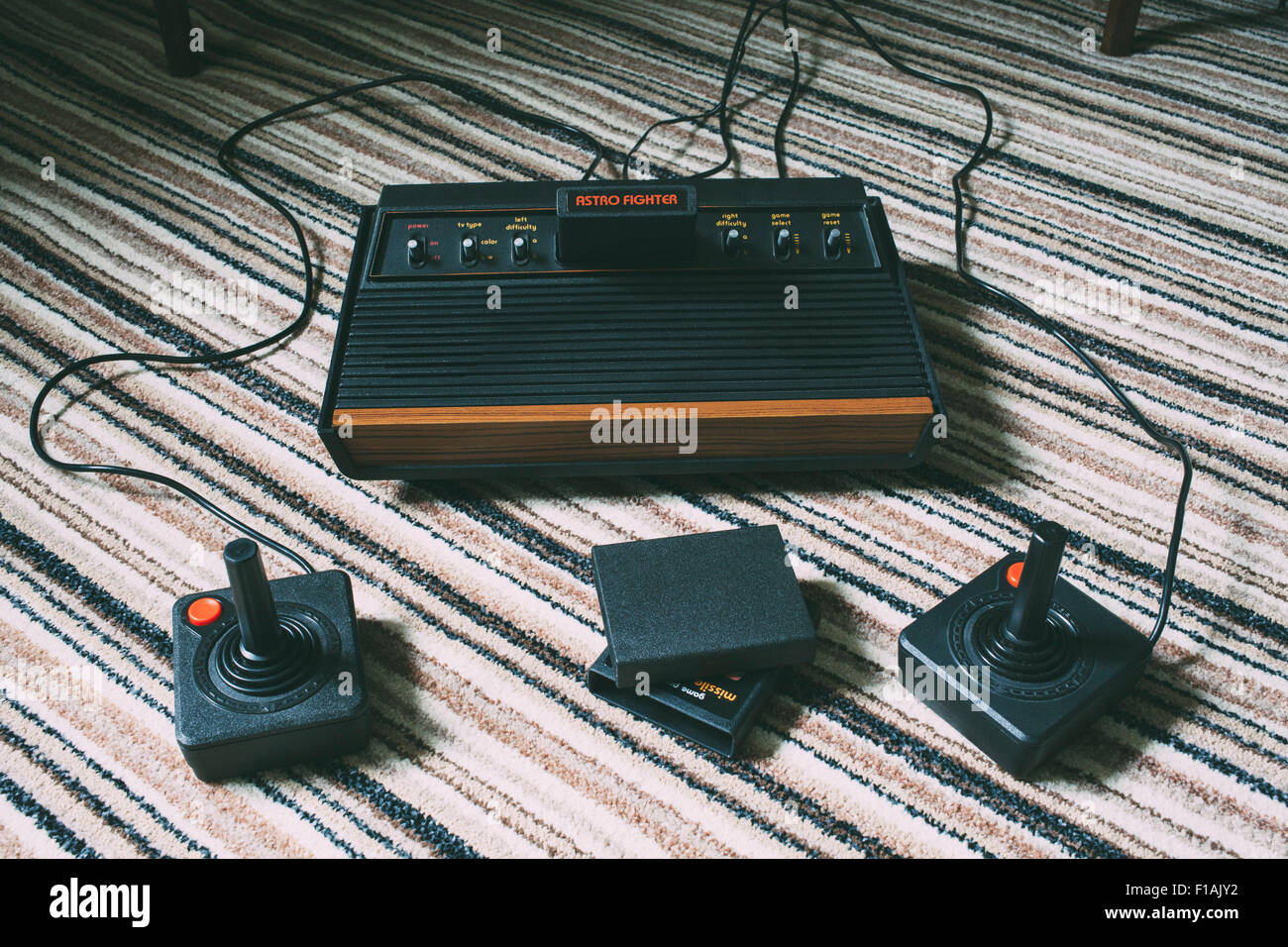 Retro Atari 2600 1970's video game console with cartridges and two joysticks Stock Photo