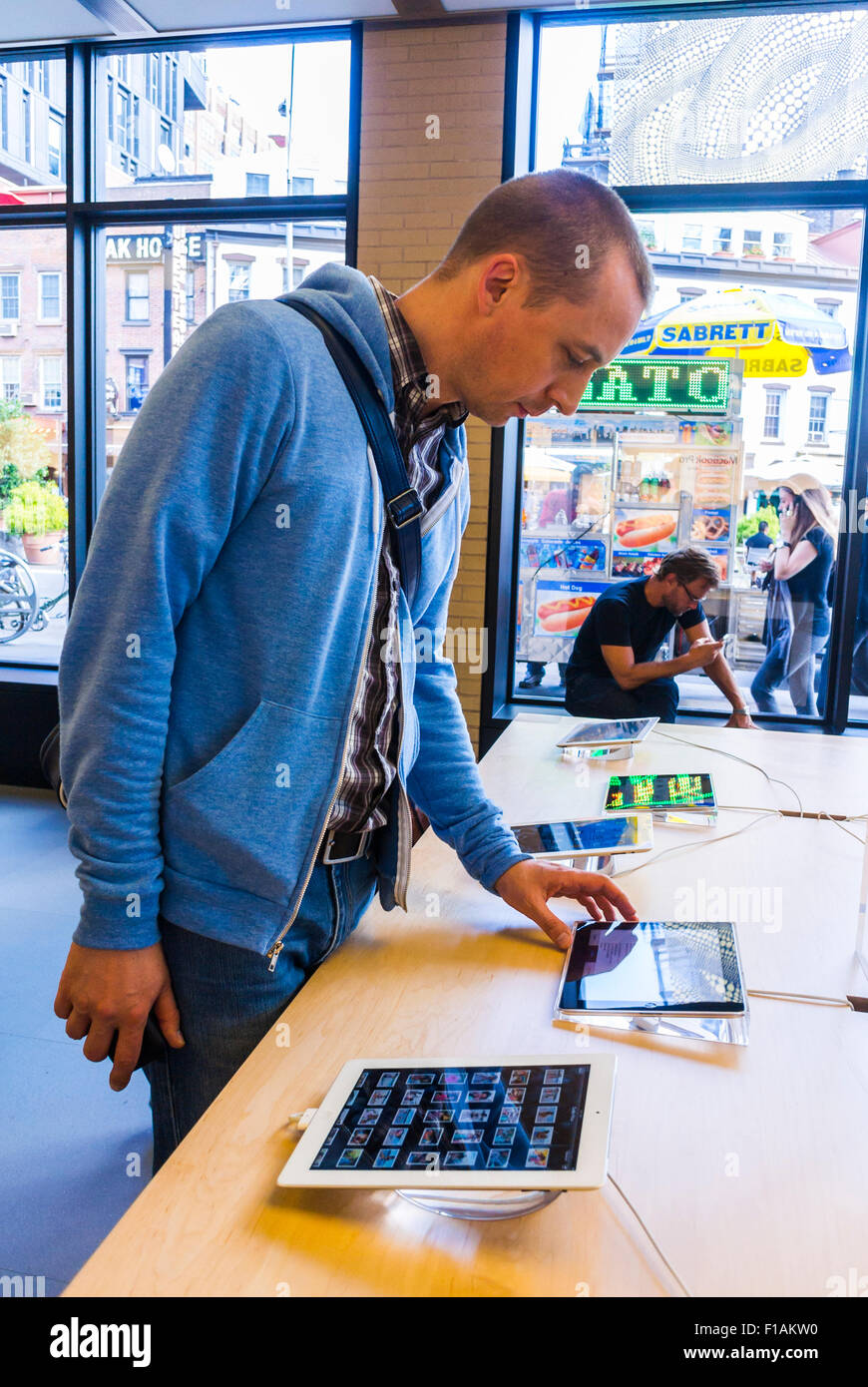 New York City, USA, Young Man Shopping inside 'Apple Store' in Manhattan, IPAD Tablets, buying tech products, apple showroom, apple boutique 'Big Tech' Stock Photo