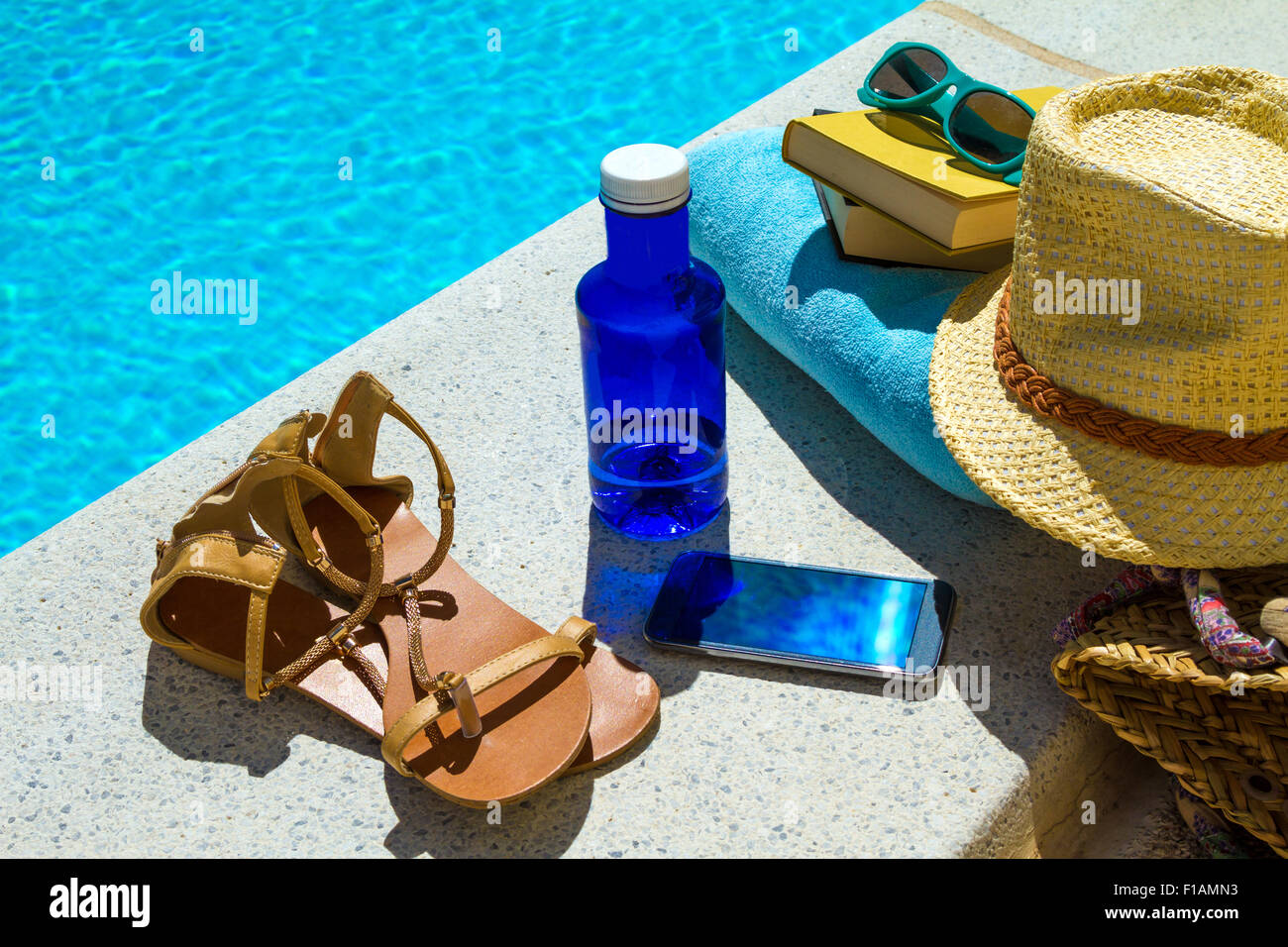 Reading near the swimming pool Stock Photo Alamy