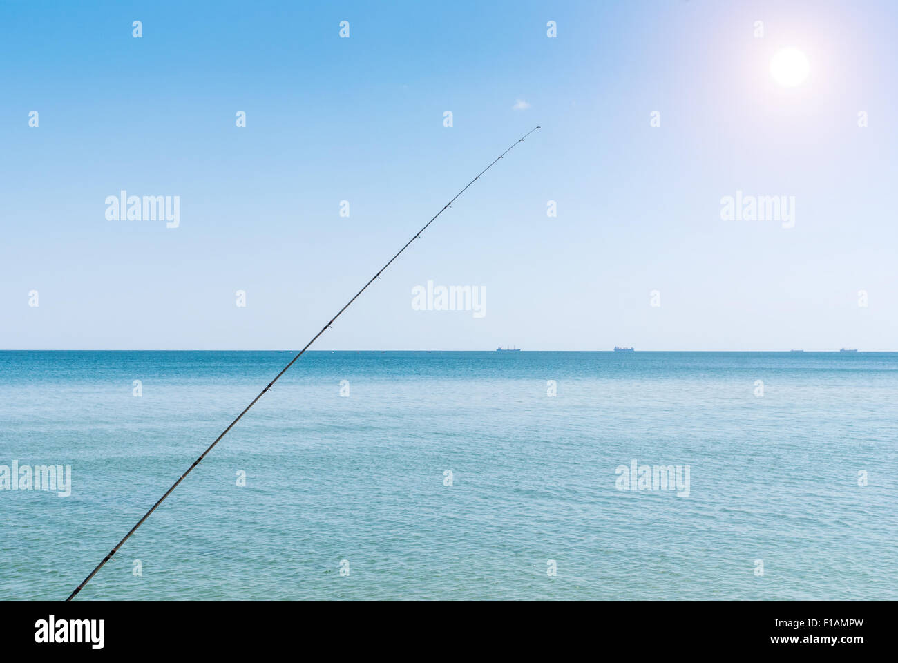 Fishing rods on the background of blue water Stock Photo
