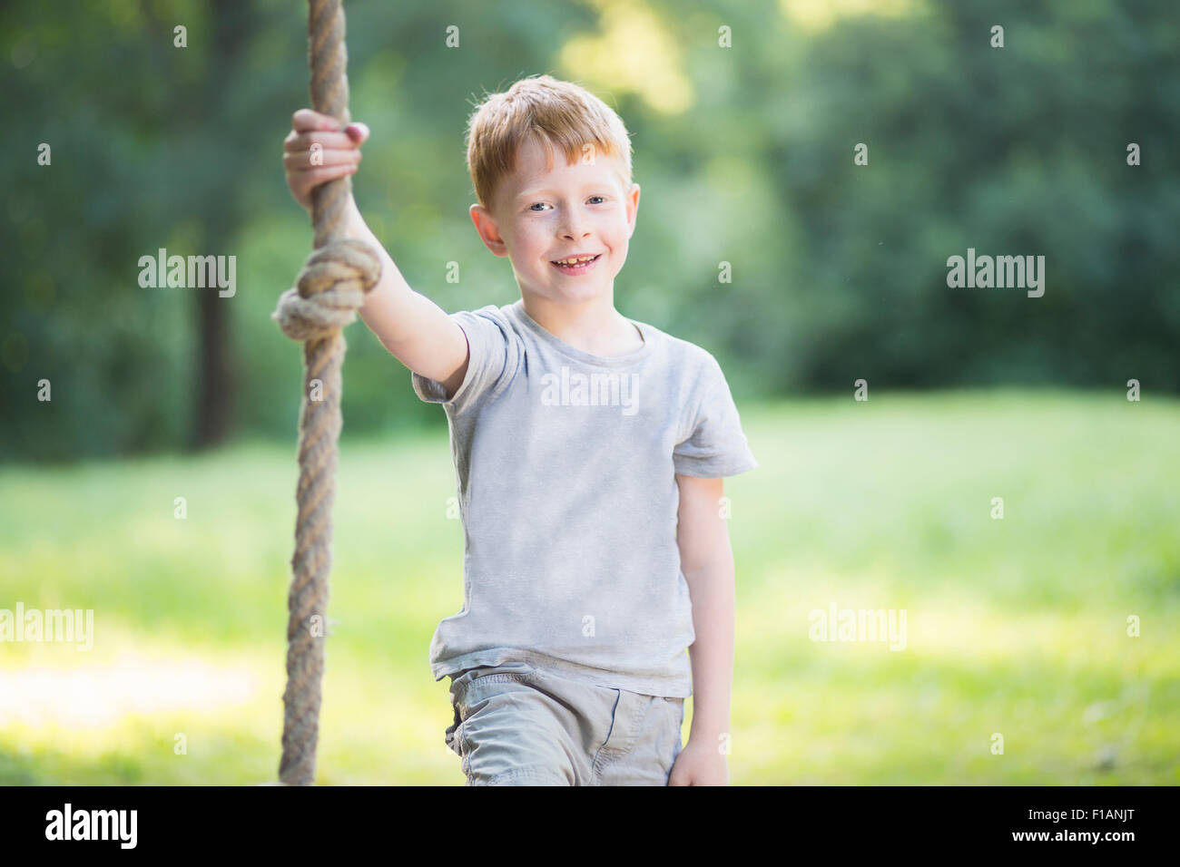 Boy Using A Rope Portrait of little boy holding a rope in a park Stock Photo - Alamy