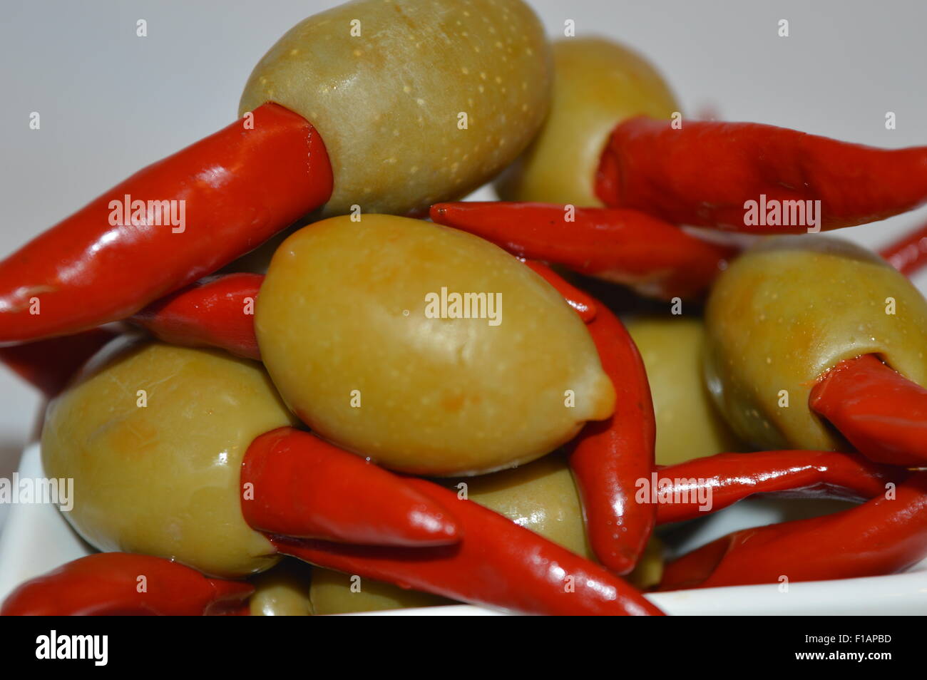 green olives stuffed with red peri-peri pepper Stock Photo - Alamy