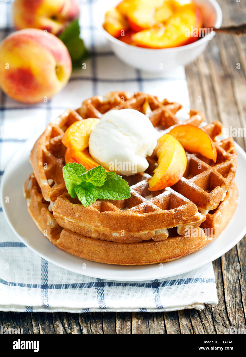Belgian waffles with ice cream and fresh peaches Stock Photo Alamy