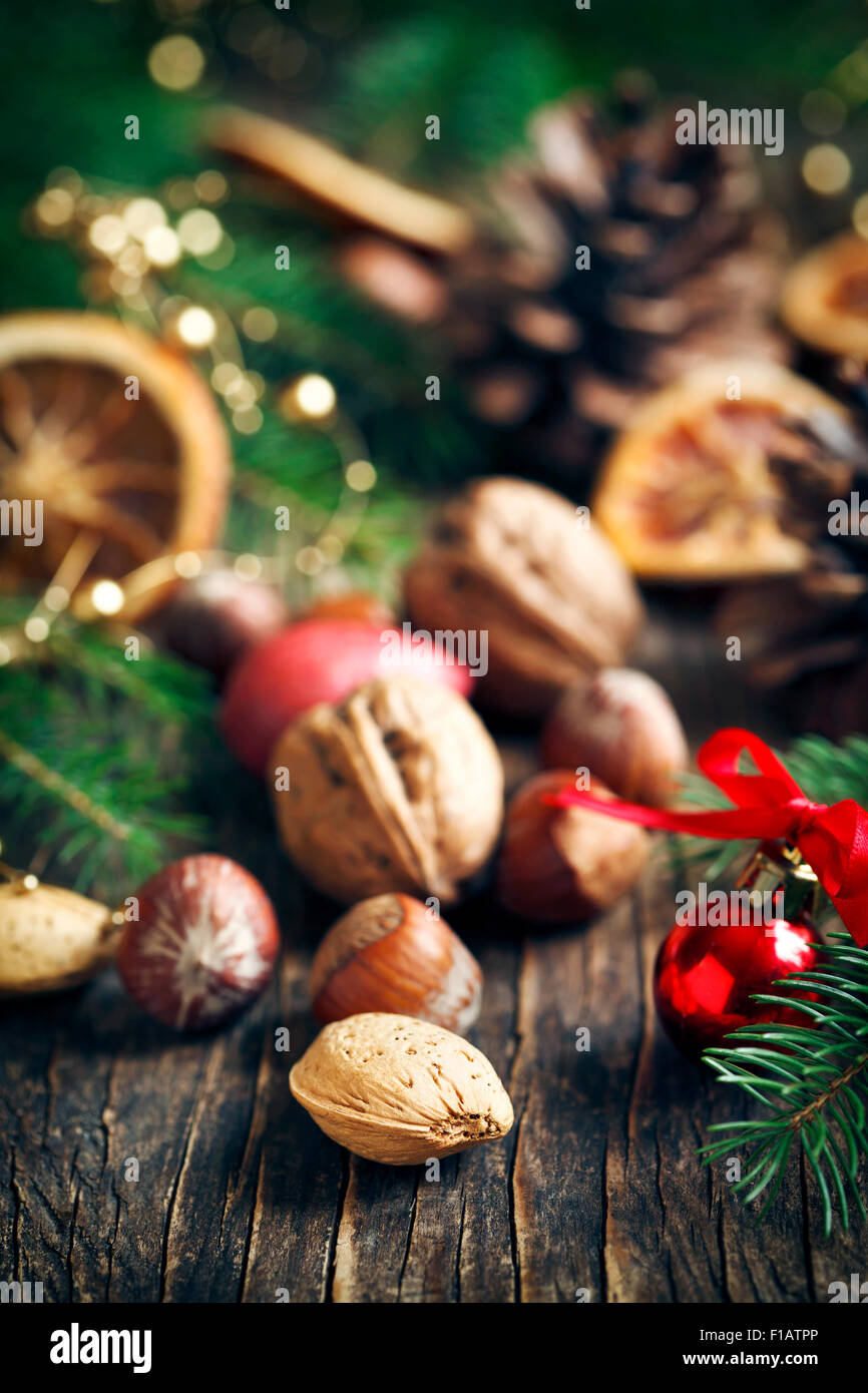 Different nuts with christmas decorations on wooden background Stock Photo