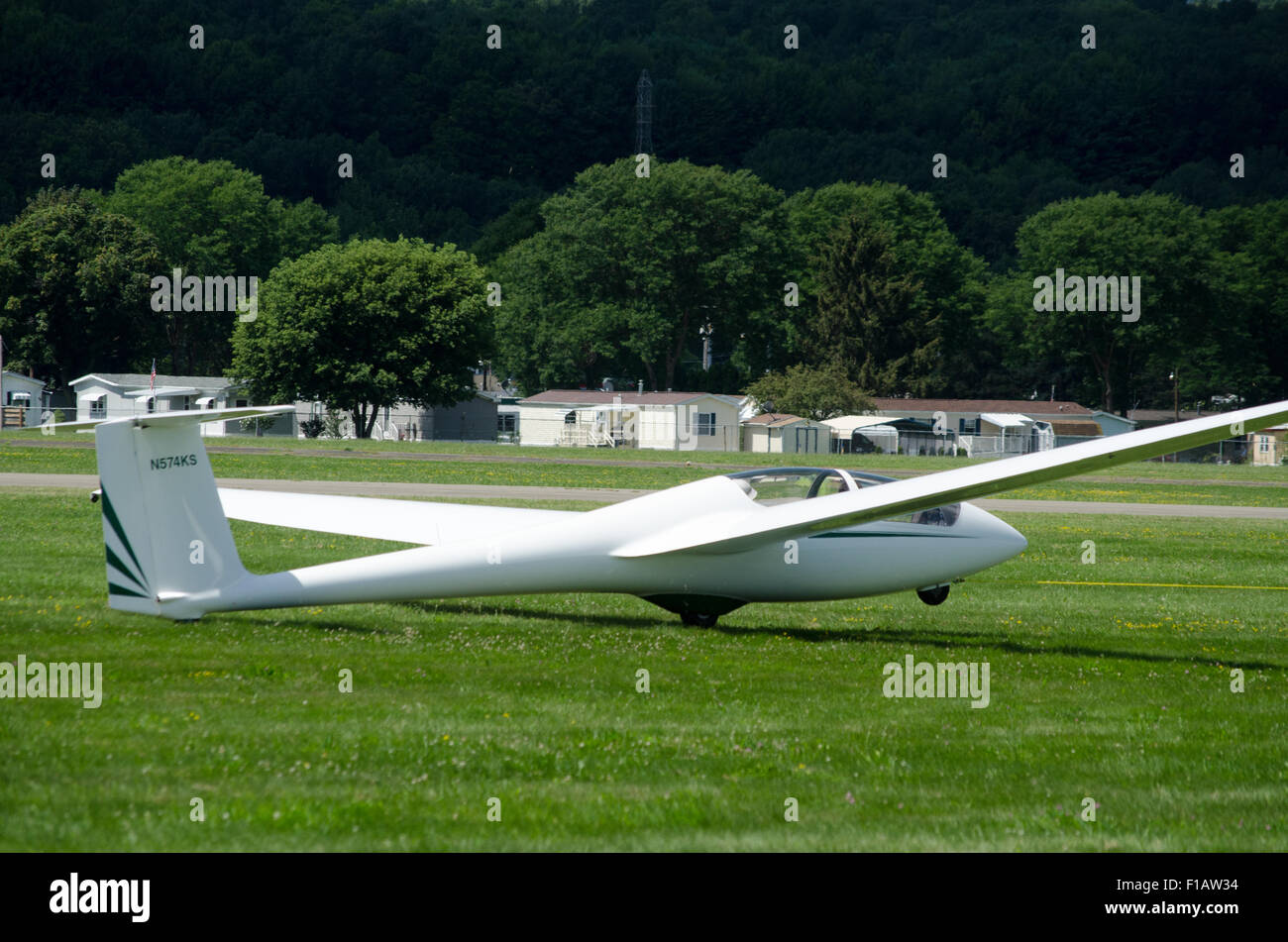 Towing sailplane on Dansville airport grass runway. Stock Photo