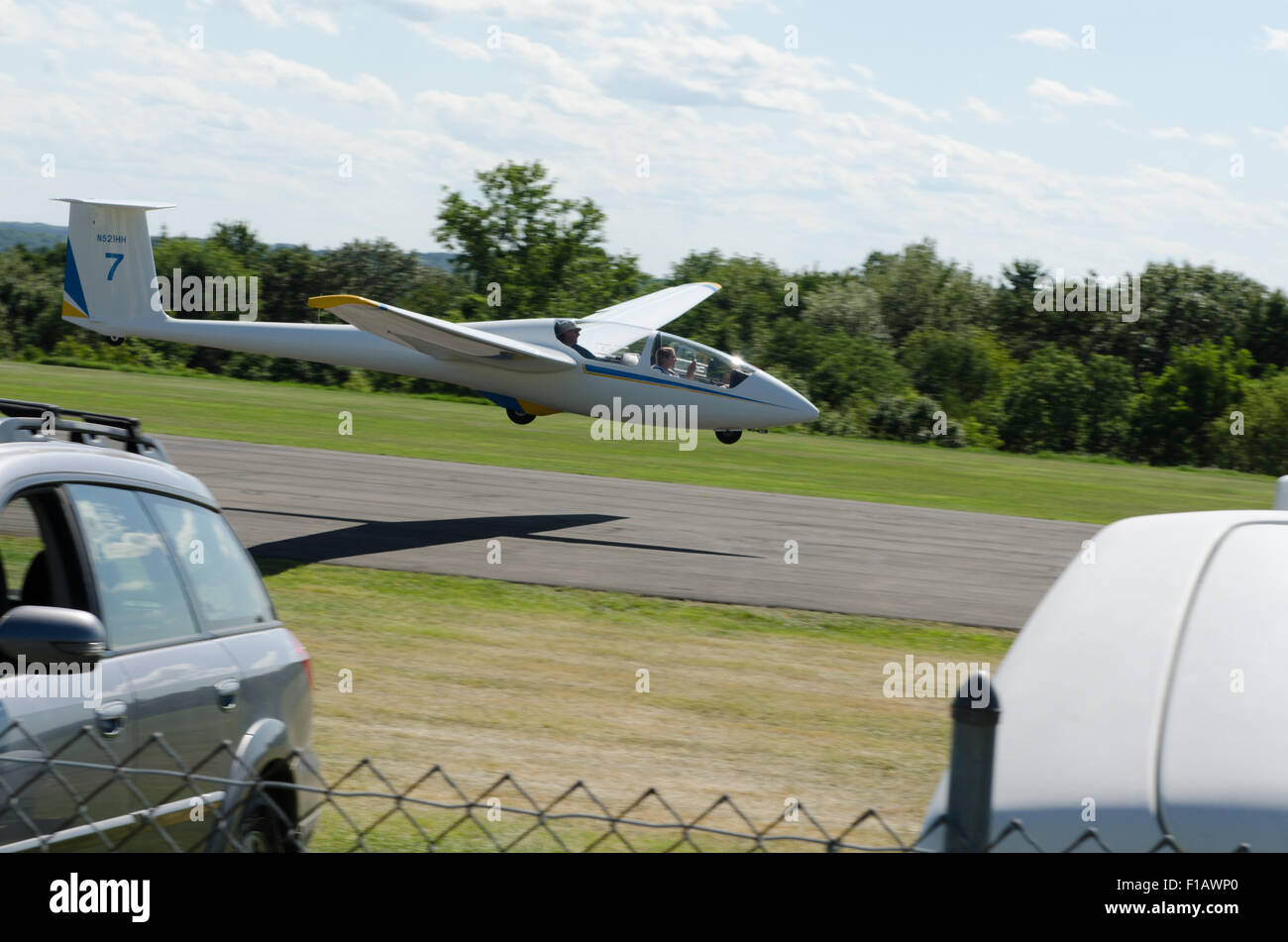 Sailplane glides runway. Stock Photo