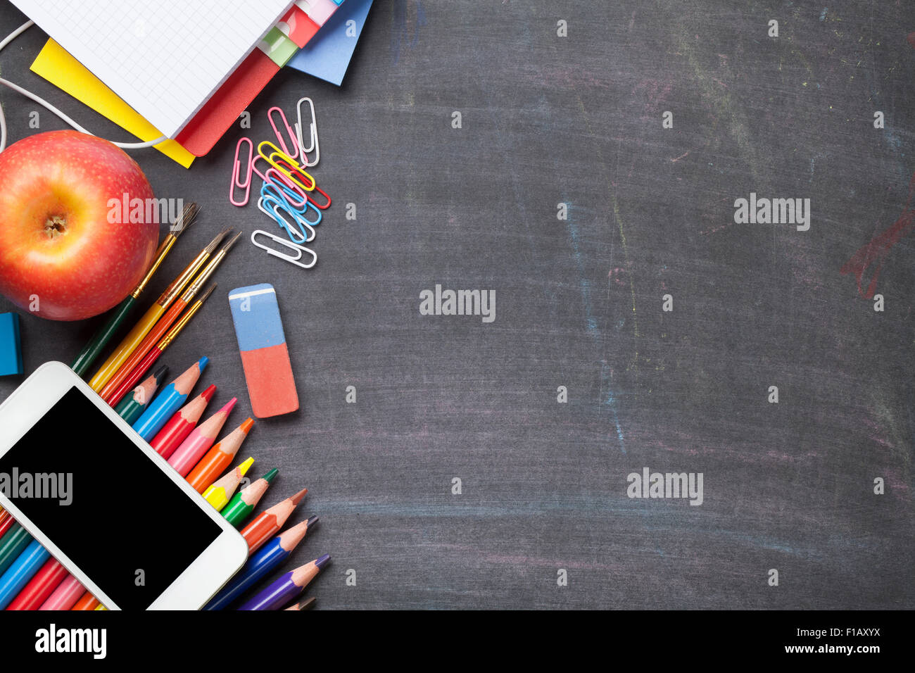 School and office supplies on blackboard background. Top view with copy ...