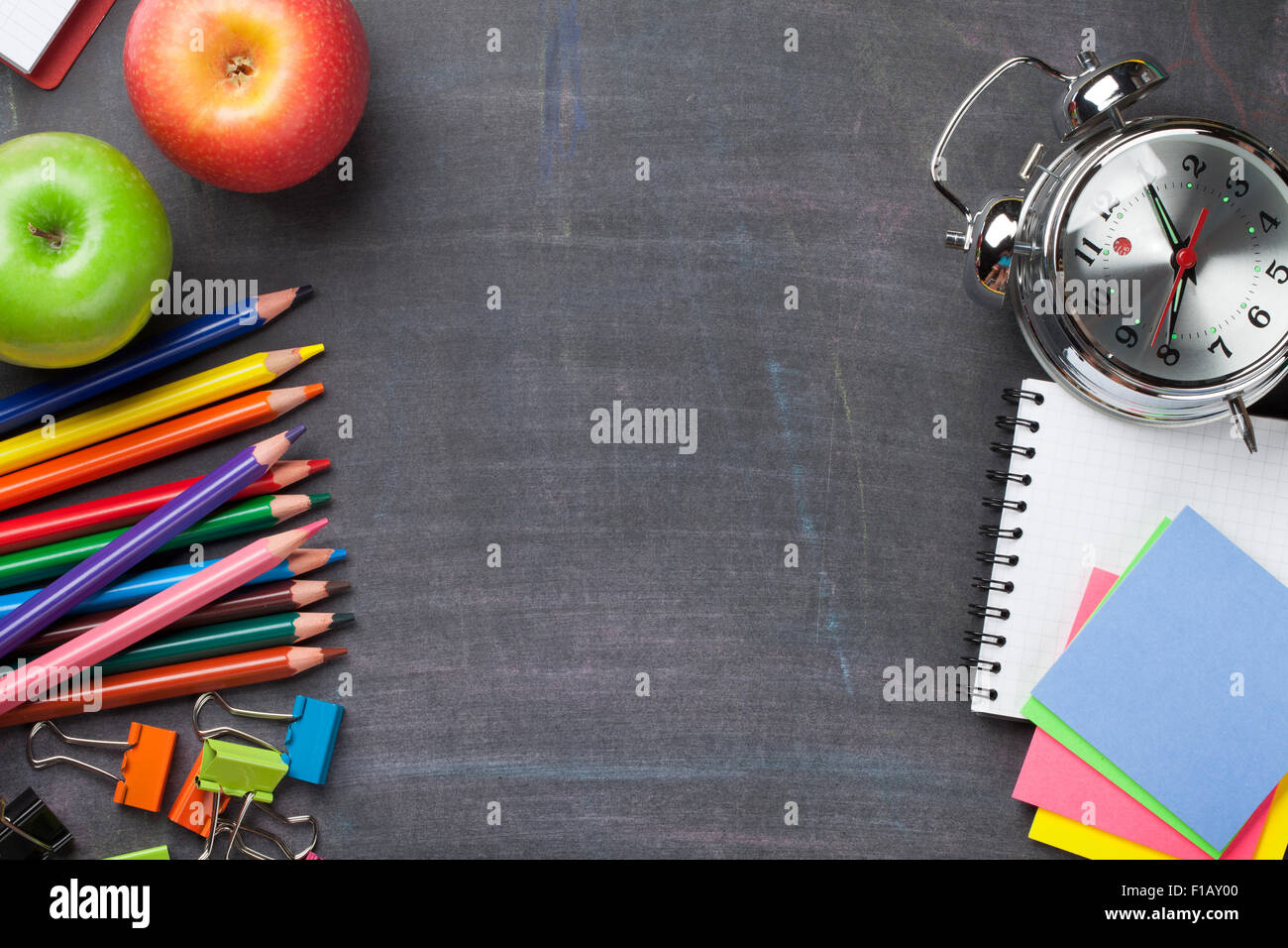 School and office supplies on blackboard background. Top view with copy ...