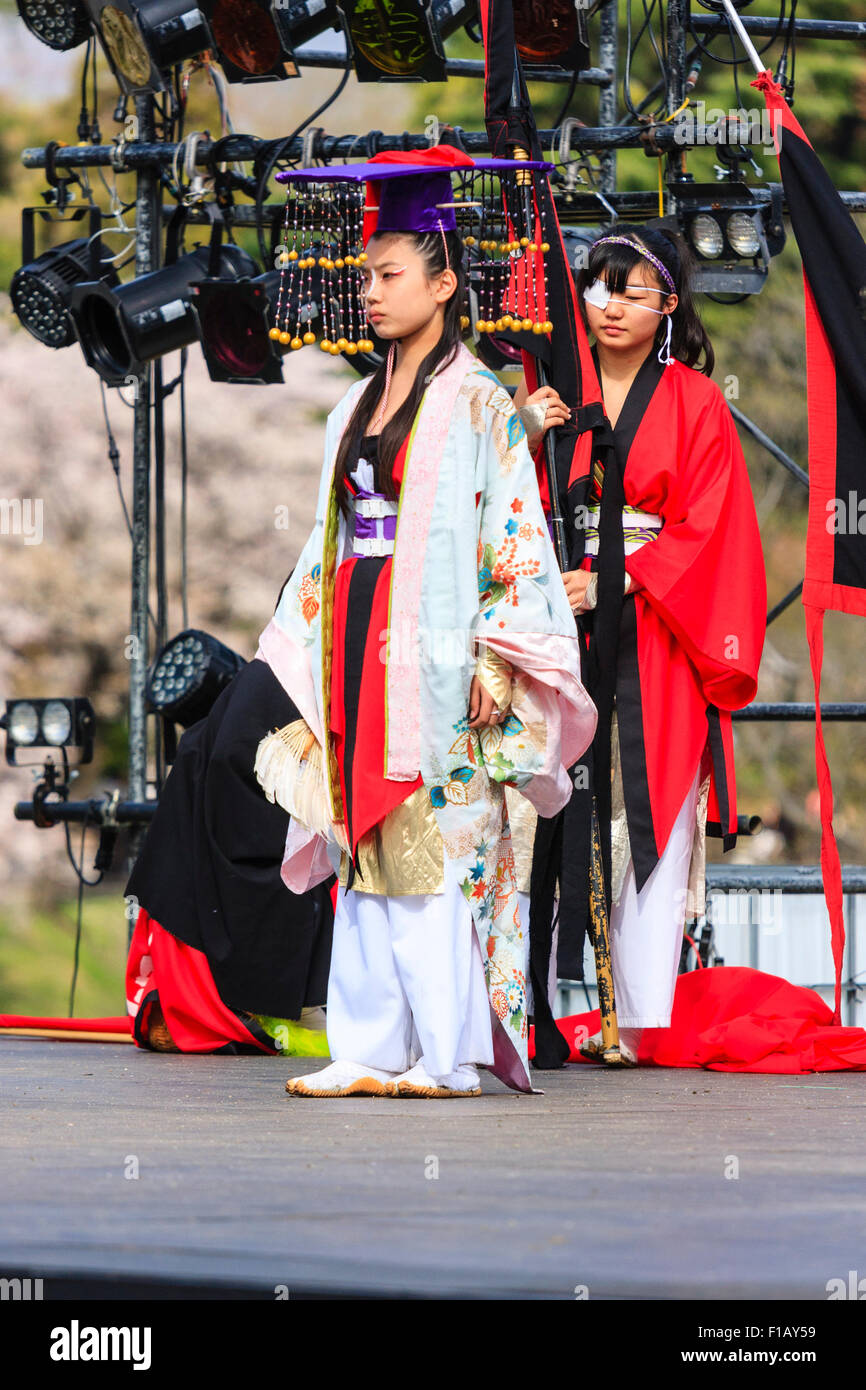Japanese Hinokuni Yosakoi Dance Festival. Woman dancer, wearing robes like some hiostorical princess, standing at front of outdoor stage. Stock Photo