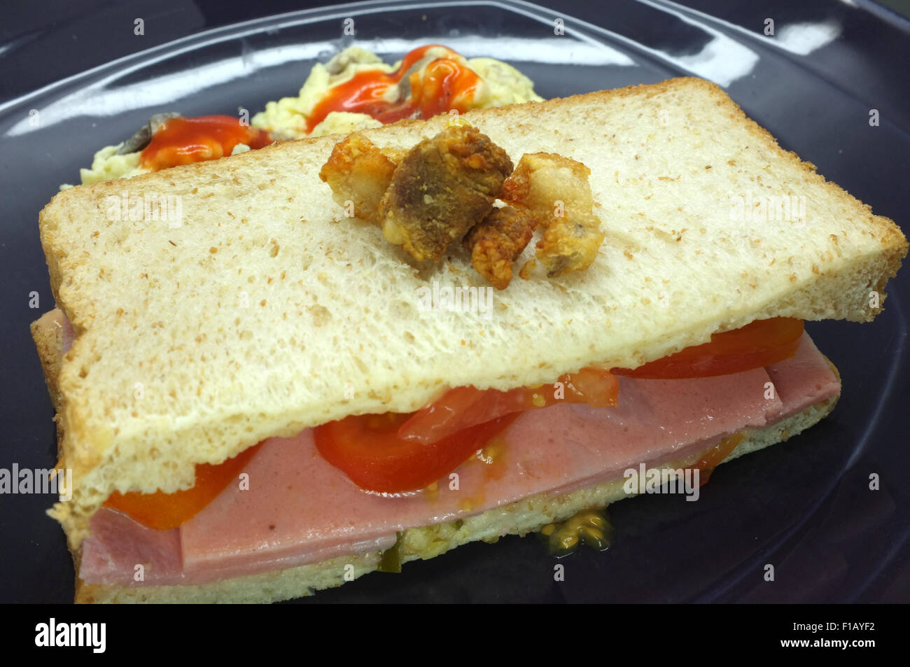 Ham and tomato sandwich with scrambled egg Stock Photo Alamy