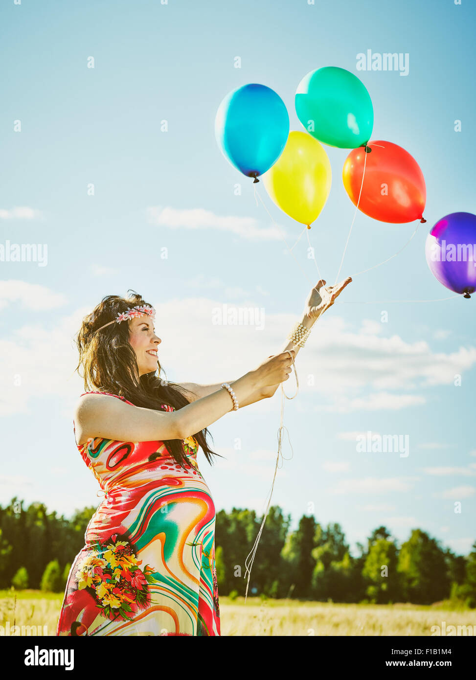 Beautiful Pregnant Young Woman Feeling Lovely And Relax Outdoors And She Plays With A Balloons